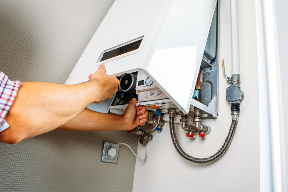 boiler vs furnace-tech repairing boiler system in home