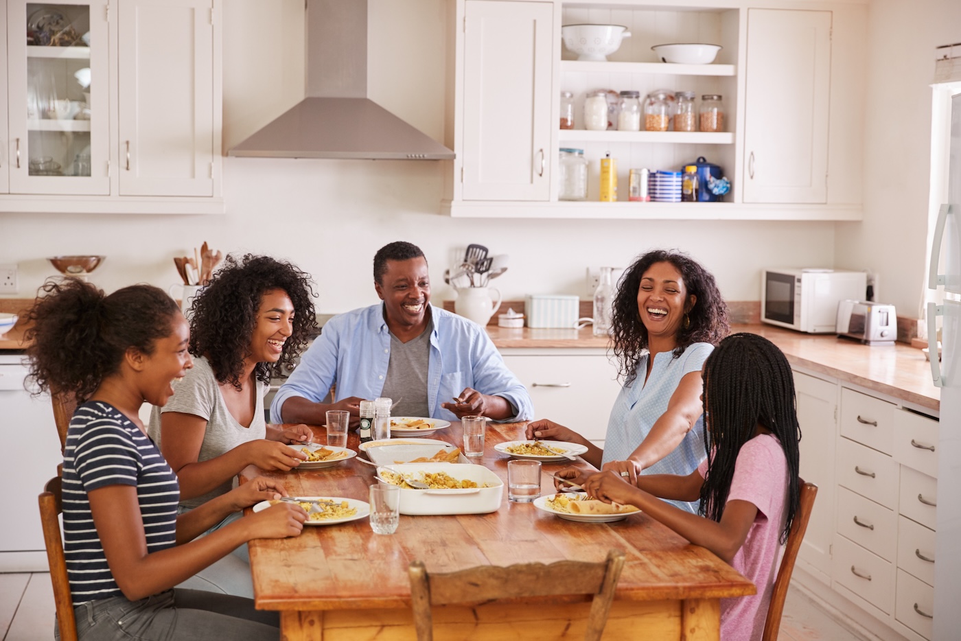 happy family eating around dinner table