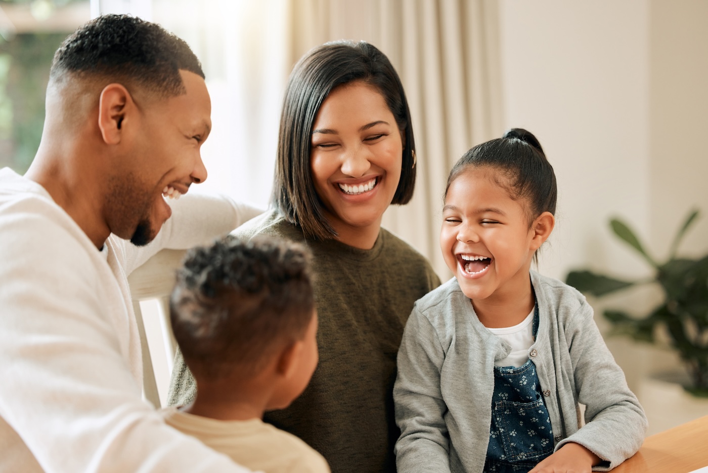 young family smiling in living room