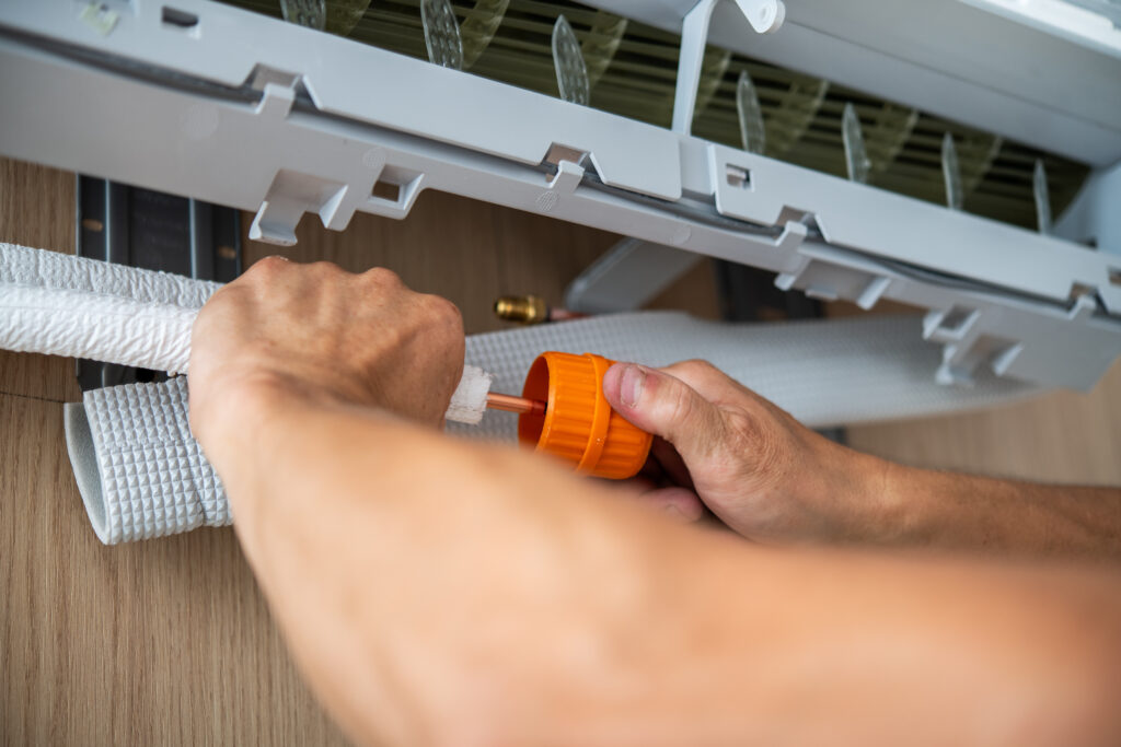 Air conditioning technicians install new air conditioners in homes, Repairman fix air conditioning systems, Male technician service for repair and maintenance of air conditioners